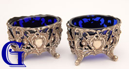 A PAIR OF COBALT BLUE SALTS IN SIVER PLATED ROCOCO STANDS
